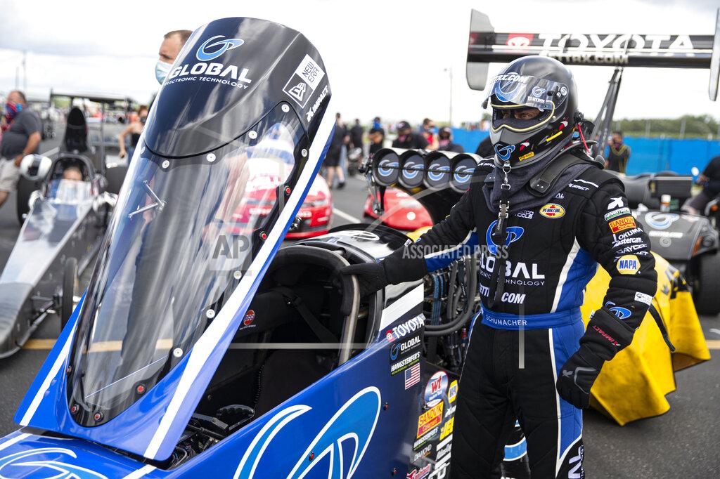 Michael Conroy Tony Schumacher waits to climbs into his Top Fuel dragster during practice for an NHRA drag racing event in Brownsburg, Ind., Friday, July 10, 2020. The NHRA returned to action last weekend near Indianapolis, in front of fans, on network television and amid hopes of a quick financial rebound following a 138-day season suspension. It was the kind of boost everybody needed. Teams and crew members are scrambling to pay the bills. Big questions remain for the world's premier drag-racing series. The pandemic is still a threat to disrupt the season or shut it down again. (AP Photo/Michael Conroy)