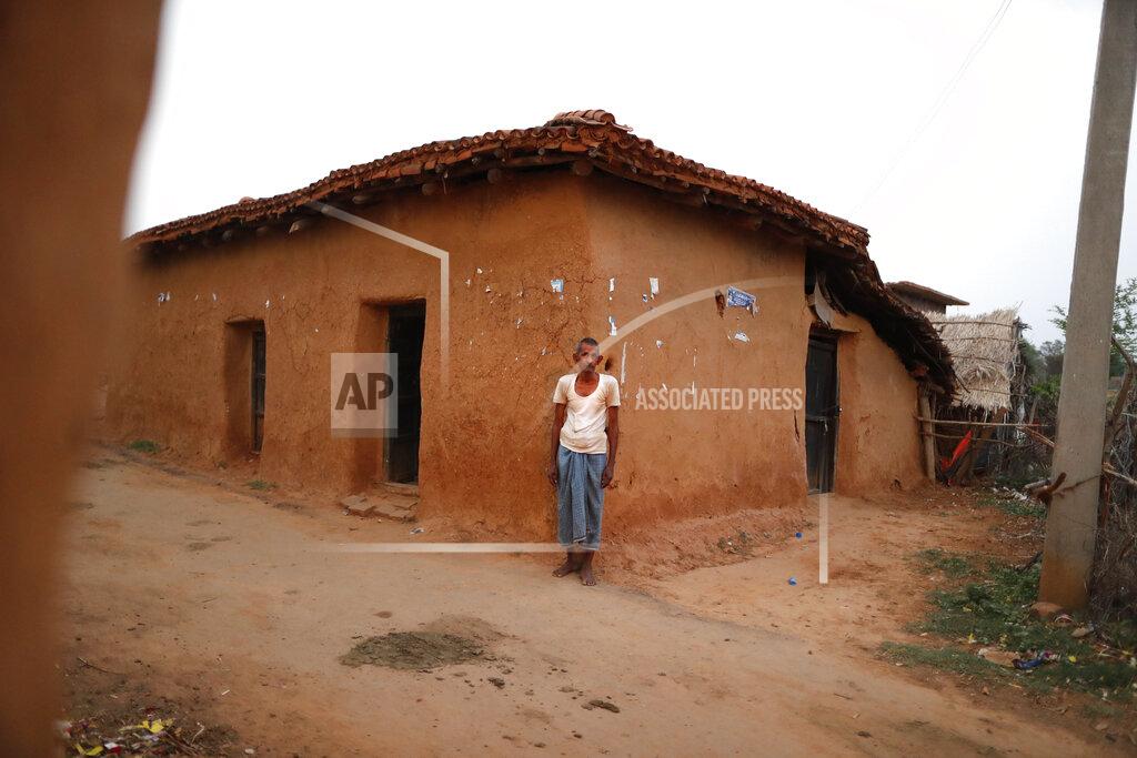 Rajesh Kumar Singh Vijayee Pratap Gupta, 60, a grocery shopkeeper and one of the few in the area to get vaccinated against COVID-19 stands outside his home in Jamsoti village, Uttar Pradesh state, India, on June 8, 2021. India's vaccination efforts are being undermined by widespread hesitancy and fear of the jabs, fueled by misinformation and mistrust. That's especially true in rural India, where two-thirds of the country’s nearly 1.4 billion people live. (AP Photo/Rajesh Kumar Singh)