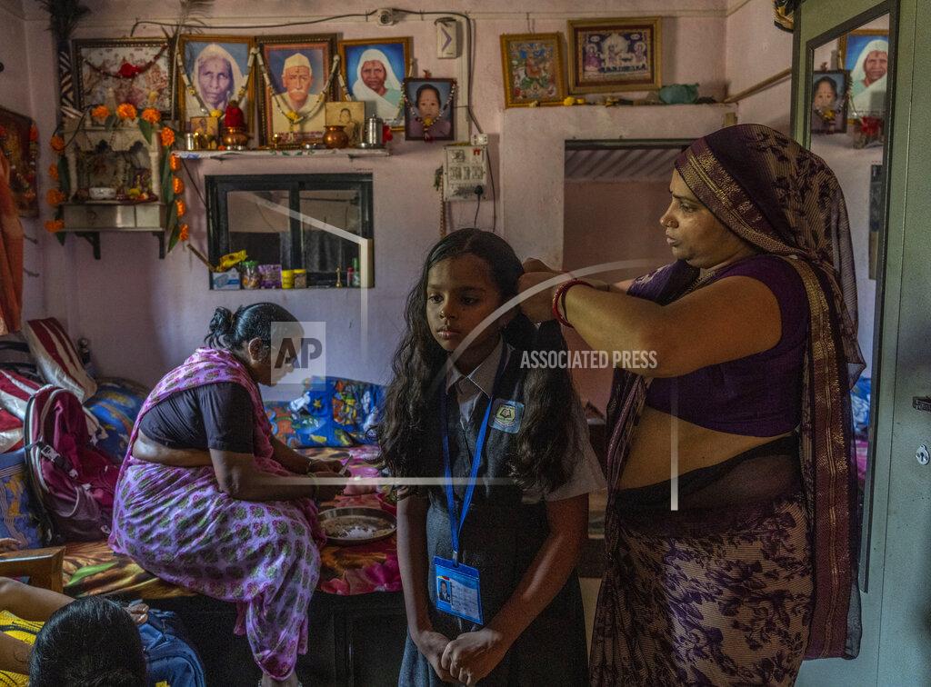 Rafiq Maqbool Kiran Lote combs the hair of her daughter Purvi Rohid as she prepares to leave for school in Aarey Colony, which borders the south end of Sanjay Gandhi National Park in Mumbai, India, Thursday, April 7, 2022. Los Angeles and Mumbai, India are the world’s only megacities of 10 million-plus where large felines breed, hunt and maintain territory within urban boundaries. Long-term studies in both cities have examined how the big cats prowl through their urban jungles, and how people can best live alongside them. (AP Photo/Rafiq Maqbool)