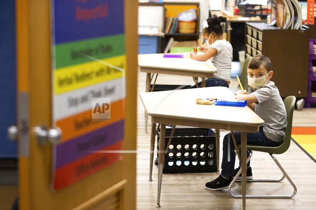 Christopher Dolan FILE—In this file photo from Aug. 27, 2020, first grade students at Dunmore Elementary Center in Dunmore, Pa., wear masks on their first day of classes. Pennsylvania Gov. Tom Wolf will ask lawmakers Wednesday, Feb. 3, 2021, to raise income taxes on higher earners and give public schools a massive boost in aid, even as he faces a gaping deficit and uncertainty over how much more pandemic relief the federal government will send.(Christopher Dolan/The Times-Tribune via AP, File)