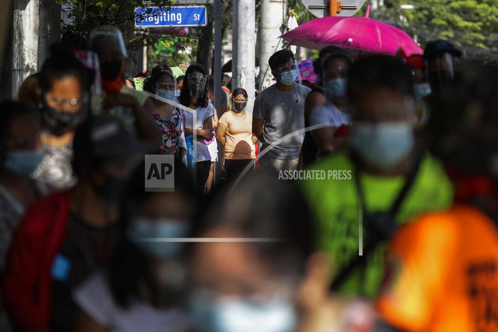 Aaron Favila FILE - In this April 19, 2021, file photo, residents wearing face mask and face shield queue to get free food at a makeshift stall called "Community Pantry" at Maginhawa street in Quezon city, Philippines. Developing Asian economies will grow at a solid 7.3% pace this year after contracting slightly in 2020 due to the pandemic, the Asian Development Bank says in its latest regional outlook. (AP Photo/Aaron Favila, File)