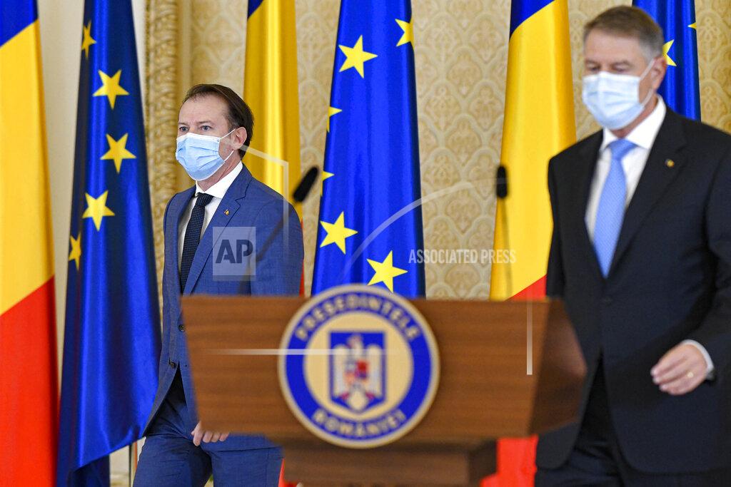 Andreea Alexandru Romanian prime minister-designate Florin Citu, left, walks next to Romanian President Klaus Iohannis shortly before his nomination in Bucharest, Romania, Tuesday, Dec. 22, 2020. Romania's president on Tuesday appointed the outgoing finance minister as prime minister-designate after three pro-Western center-right groups joined forces to keep out of power a left-leaning populist party that won most votes at a parliamentary election earlier this month. (AP Photo/Andreea Alexandru)