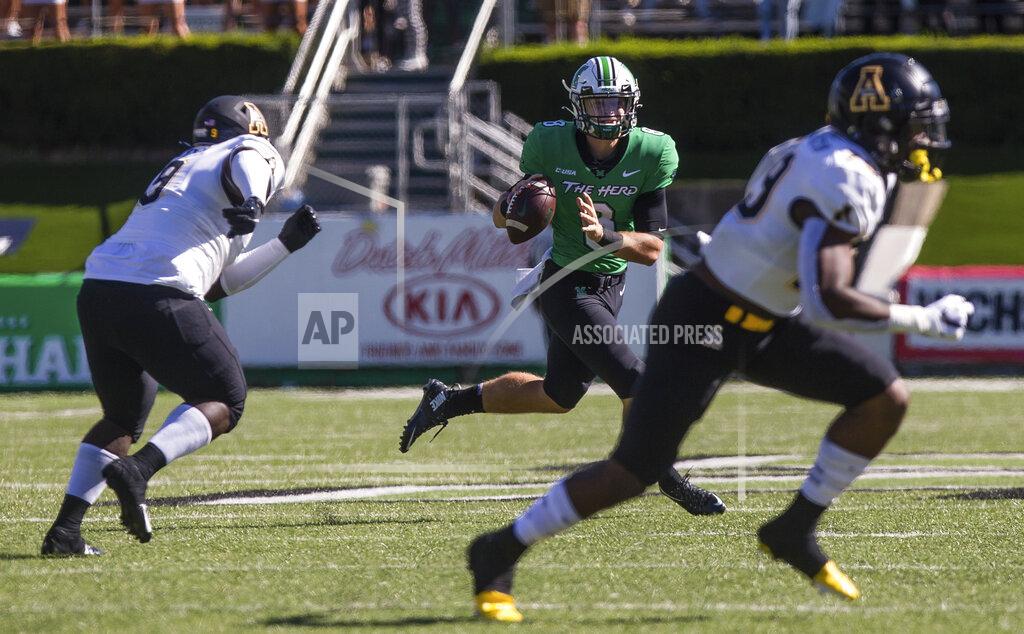 Sholten Singer Marshall quarterback Grant Wells (8) rolls out of the pocket to make a throw against Appalachian State during an NCAA college football game Saturday, Sept. 19, 2020, in Huntington, W.Va. (Sholten Singer/The Herald-Dispatch via AP)