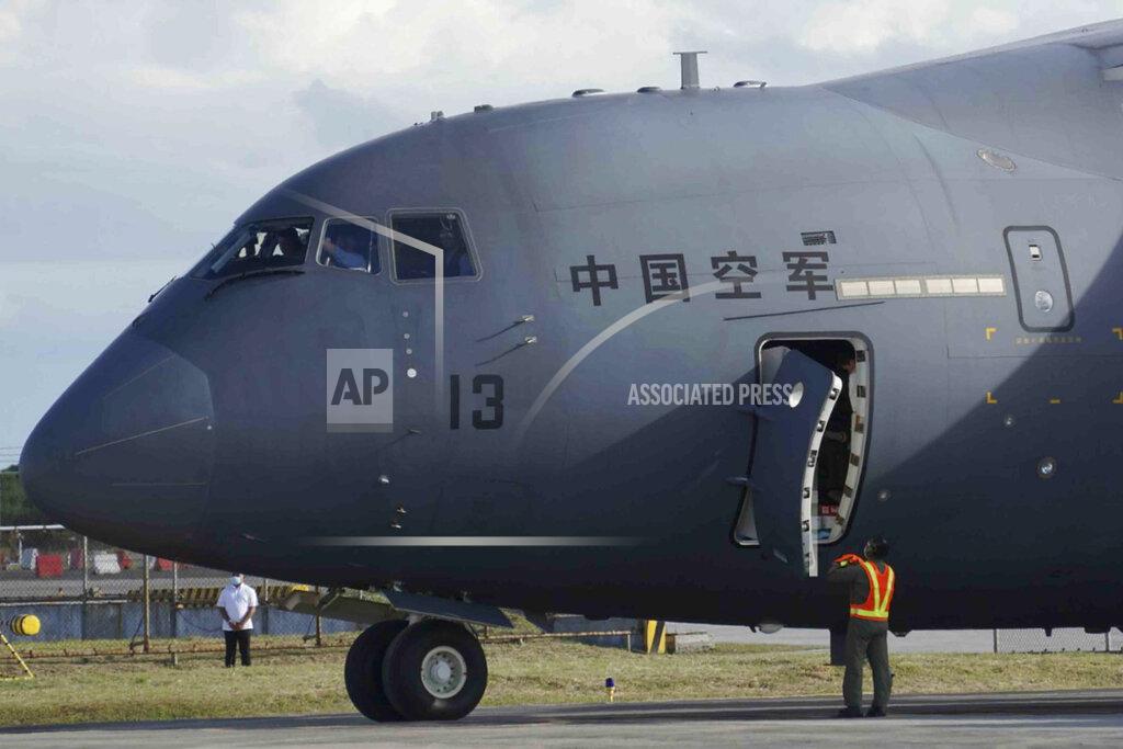 Uncredited In this photo provided by the Presidential Communications Operations Office-Office of the Global Media Public Affairs, a Chinese military plane carrying the first batch of Sinovac vaccine from China arrives at the Villamor Air Base in Manila, Philippines on Sunday Feb. 28, 2021. The Philippines is due to receive its first batch of COVID-19 vaccine Sunday, among the last in Southeast Asia to secure the critical doses despite having the second-highest number of coronavirus infections and deaths in the hard-hit region. (PCOO-OGMPA via AP)