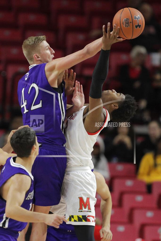 Julio Cortez Holy Cross forward Blake Verbeek (42) applies a block on Maryland guard Hakim Hart, right, during the second half of an NCAA college basketball game, Tuesday, Nov. 5, 2019, in College Park, Md. Maryland won 95-71. (AP Photo/Julio Cortez)