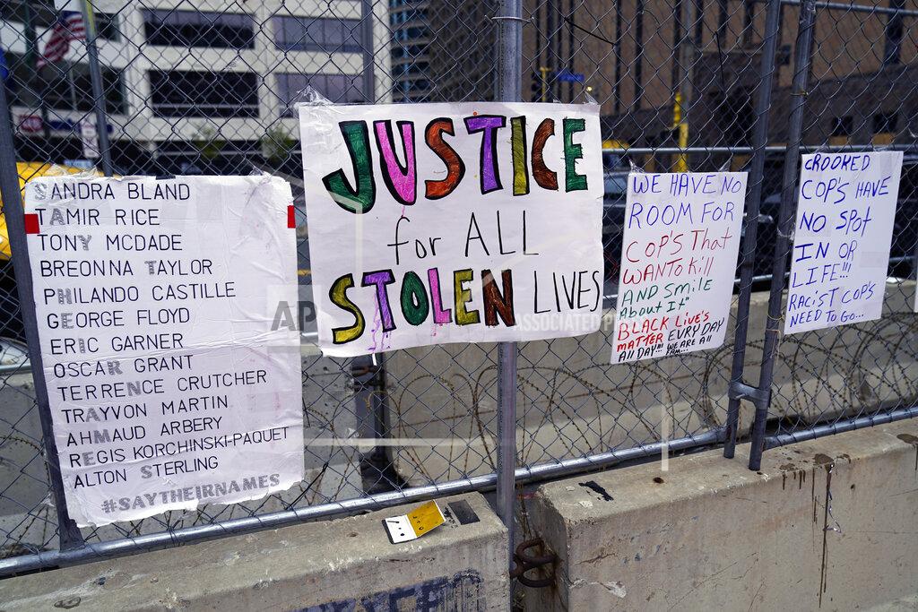 Jim Mone New signs are on a fence at the Hennepin County Government Center, Monday, April 19, 2021, in Minneapolis where closing arguments are being heard in the trial of former Minneapolis police officer Derek Chauvin continues. Chauvin is charged with murder in the death of George Floyd during an arrest last may in Minneapolis. (AP Photo/Jim Mone)