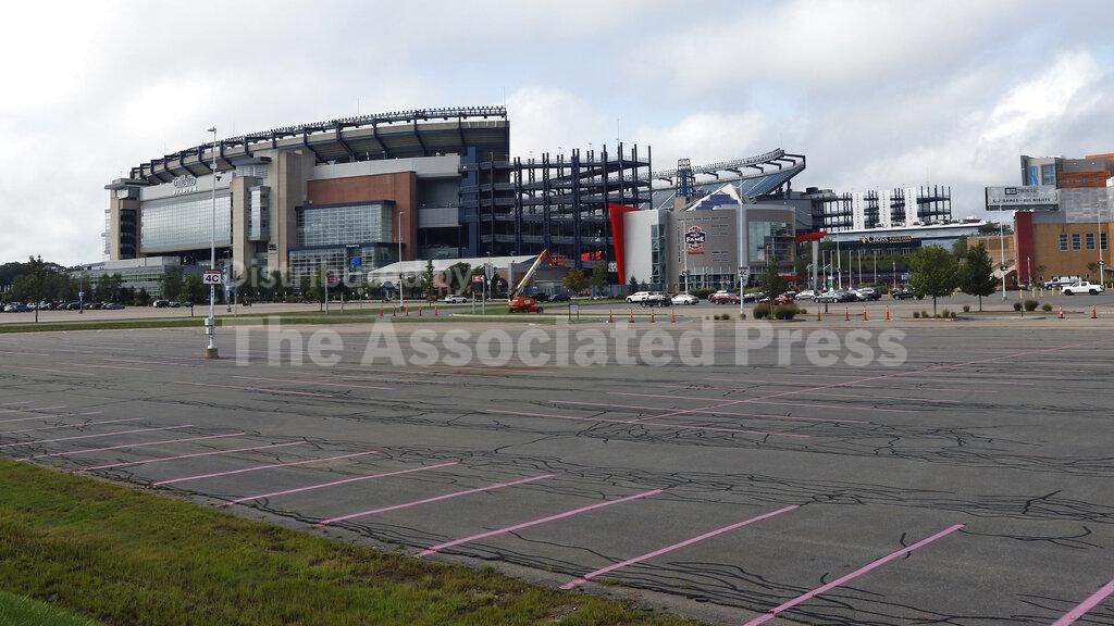 A parking lot outside Gillette Stadium is unused by tailgating fans before an NFL football game between the New England Patriots and Miami Dolphins, Sunday, Sept. 13, 2020, in Foxborough, Mass. (AP Photo/Bill Sikes)