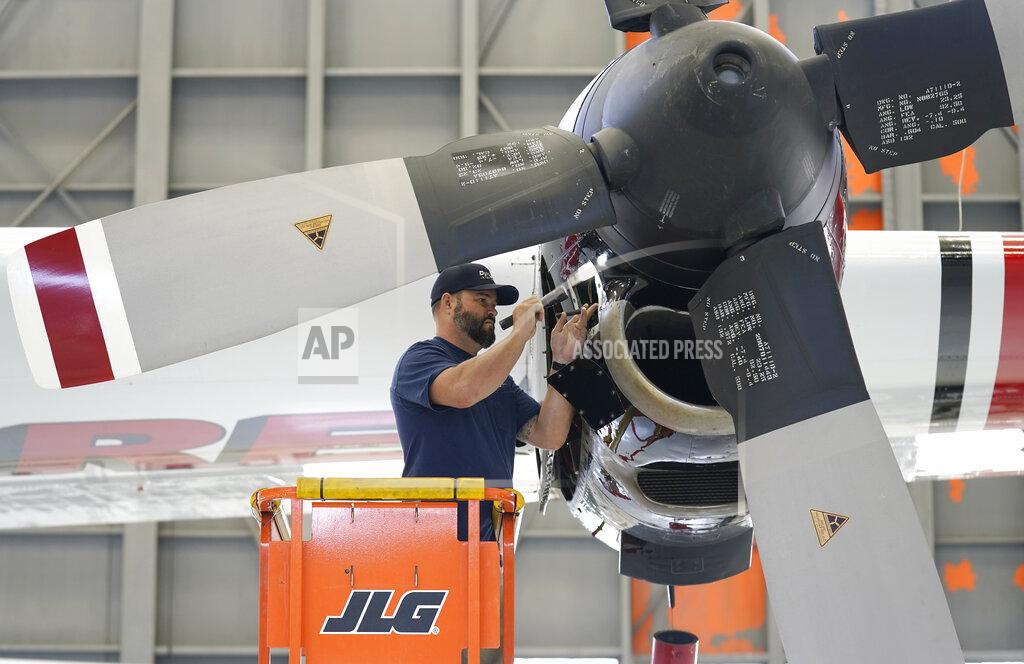 Rich Pedroncelli Aircraft Mechanic Cody Poole inspect one of the engines on a recently acquired C-130 aircraft, that will be used for firefighting, hangared at the California Department of Forestry and Fire Protection's Sacramento Aviation Management Unit based at McClellan Airpark in Sacramento, Calif., Friday, July 23, 2021. Firefighters are trying to become smarter in how they prepare for the drought- and wind-driven wildfires that have become more dangerous across the American West in recent years, including by adding aircraft like the Sikorsky Firehawk helicopters or military surplus C-130 transport aircraft retrofitted to drop fire retardant. (AP Photo/Rich Pedroncelli)