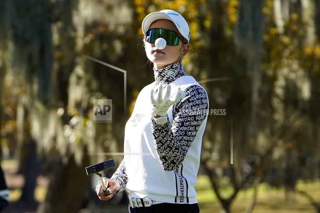 David J. Phillip Erika Hara, of Japan, reaches to catch her ball on the first green during a practice round at the U.S. Women's Open golf championship Tuesday, Dec. 8, 2020, in Houston.(AP Photo/David J. Phillip)