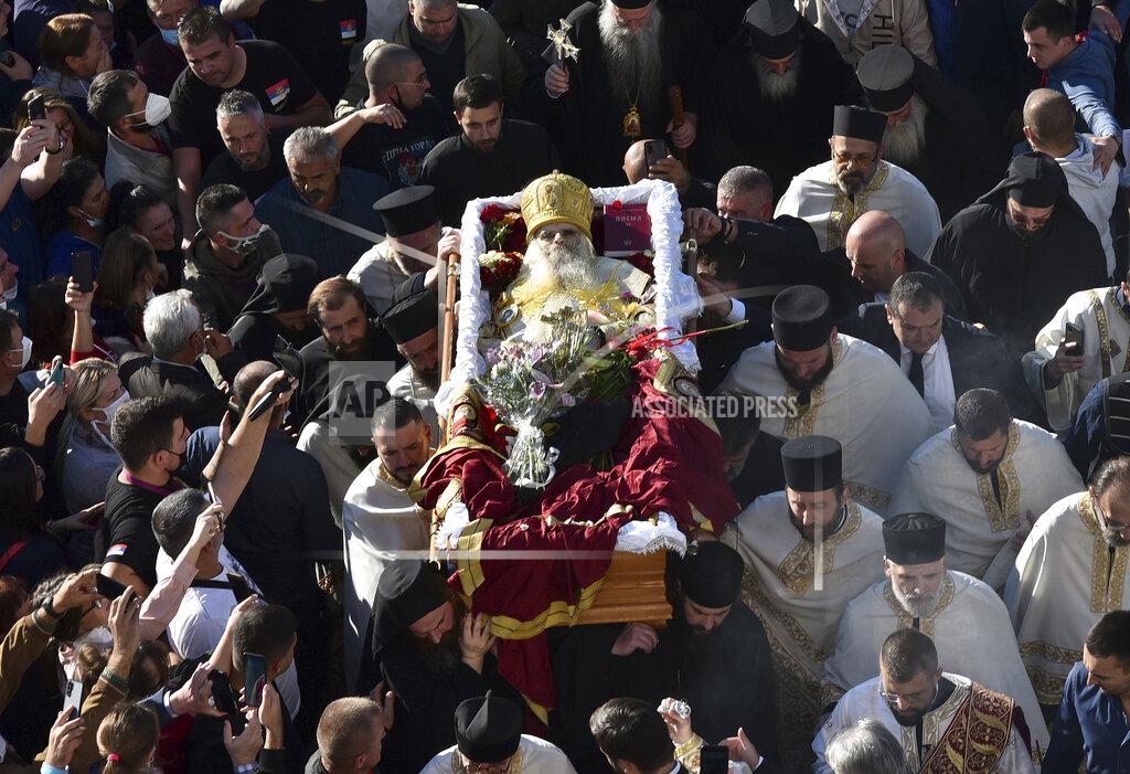 Risto Bozovic Believers carry coffin of Bishop Amfilohije, the head of the Serbian Orthodox Church in Montenegro, in Podgorica, Montenegro, Saturday, Oct. 31, 2020. The church said the 82-year-old died Friday from pneumonia caused by COVID-19. Amfilohije, known for his staunch anti-Western and pro-Russian political views, played a key role in leading the anti-government protests and putting together an opposition coalition that is currently trying to form the country's new government. (AP Photo/Risto Bozovic)