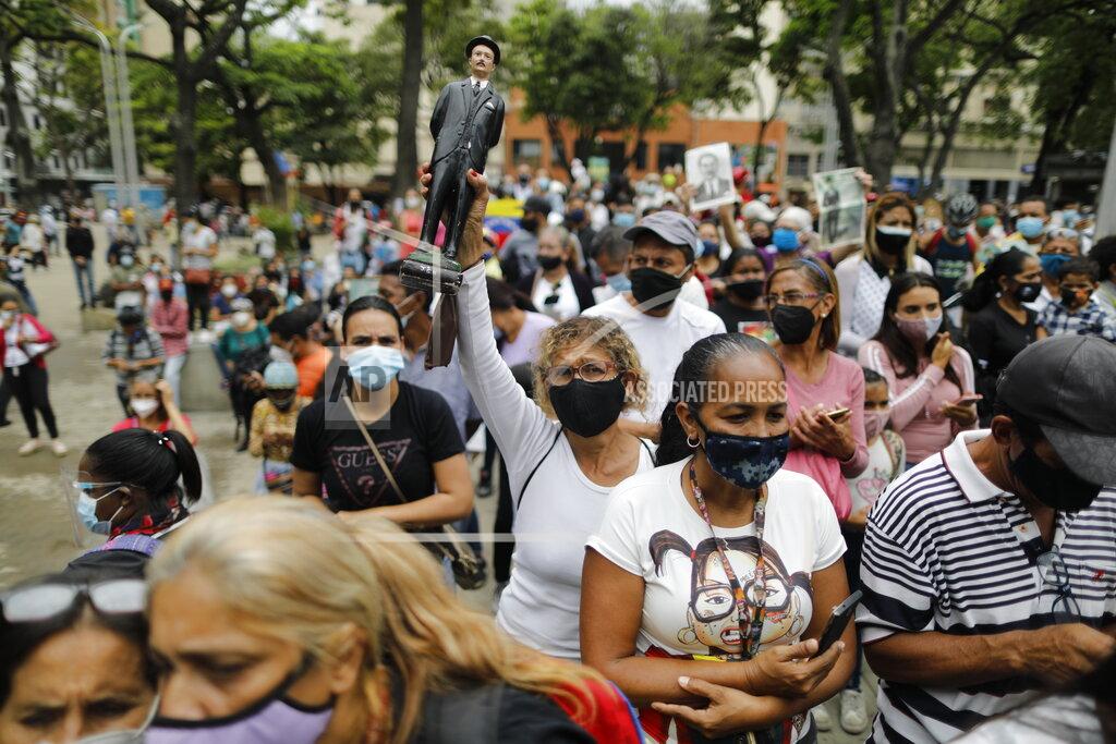 Ariana Cubillos People gather outside the church associated with the remains of the late, Venezuelan Dr. Jose Gregorio Hernandez during his beatification ceremony in the La Candelaria neighborhood of Caracas, Venezuela, Friday, April 30, 2021. Known as the "doctor of the poor," Hernandez is being beatified by the Catholic church, a step towards sainthood. (AP Photo/Ariana Cubillos)