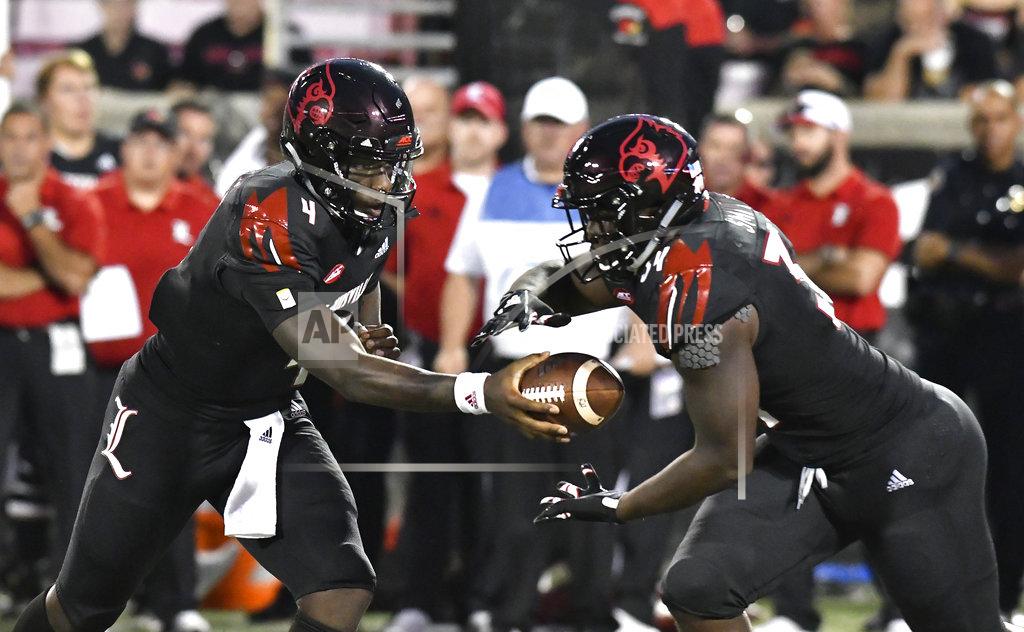 Timothy D. Easley Louisville quarterback Jawon Pass (4) hands the ball off to running back Jeremy Smith (34) during the first half of an NCAA college football game against Georgia Tech, Friday, Oct. 5, 2018, in Louisville, Ky. (AP Photo/Timothy D. Easley)