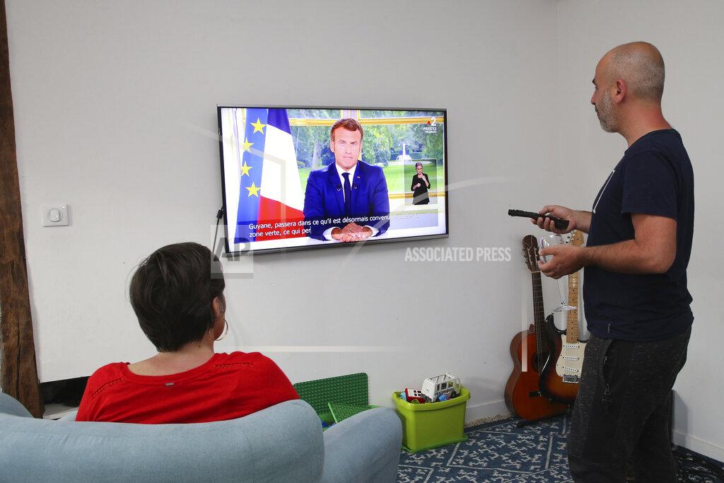 Bob Edme The family Ithurrioz watches French President Emmanuel Macron during his televised address, in Bayonne, southwestern France, Sunday, June 14, 2020. French President Emmanuel Macron is giving an address to his nation after an unusually long silence, as France faces both exceptional economic blowback from the virus pandemic and rekindled anger over deep-seated racism. (AP Photo/Bob Edme)