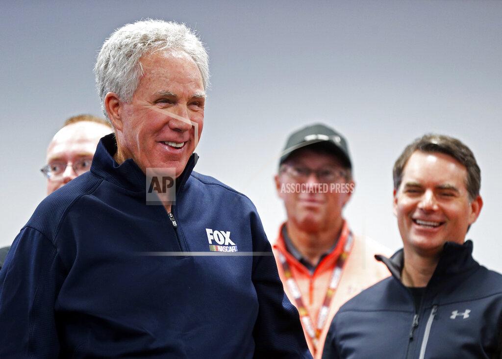 Wade Payne Hall of Fame driver and FOX television announcer Darrell Waltrip laughs with friends as he enters the media center before a press conference announcing his retirement from the booth, before practice for a NASCAR Cup Series auto race, Friday, April 5, 2019, in Bristol, Tenn. Former driver and booth mate Jeff Gordon is to the right. (AP Photo/Wade Payne)