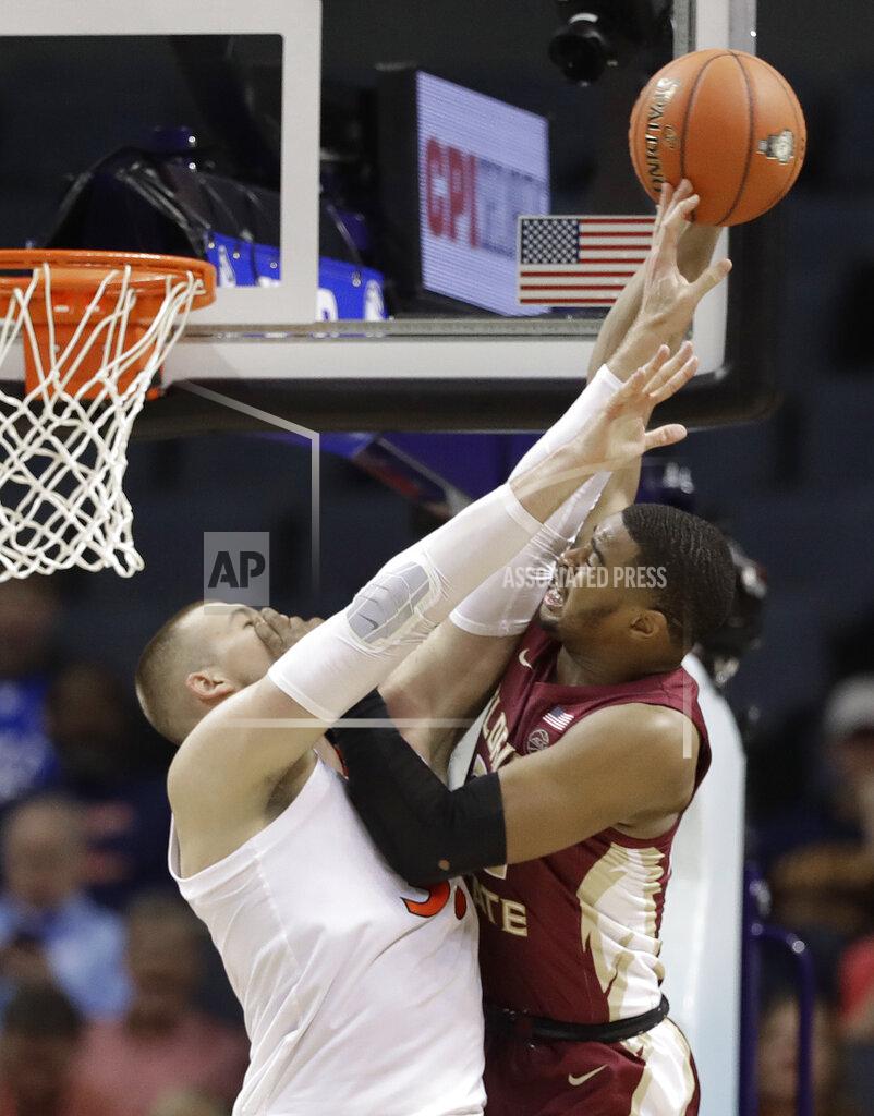 Chuck Burton Florida State's Christ Koumadje, right, is fouled by Virginia's Jack Salt, left, during the first half of an NCAA college basketball game in the Atlantic Coast Conference tournament in Charlotte, N.C., Friday, March 15, 2019. (AP Photo/Chuck Burton)