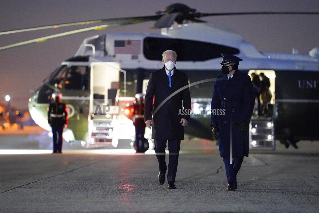 President Joe Biden walks to board Air Force One for a trip to Camp David, Friday, Feb. 12, 2021, in Andrews Air Force Base, Md. (AP Photo/Evan Vucci)