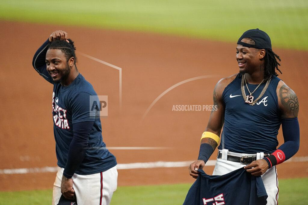 Brynn Anderson Atlanta Braves' Ronald Acuna Jr. right, celebrates with Ozzie Albies, left, after a baseball game to clinch the NL East title against the Miami Marlins on Tuesday, Sept. 22, 2020, in Atlanta. (AP Photo/Brynn Anderson)