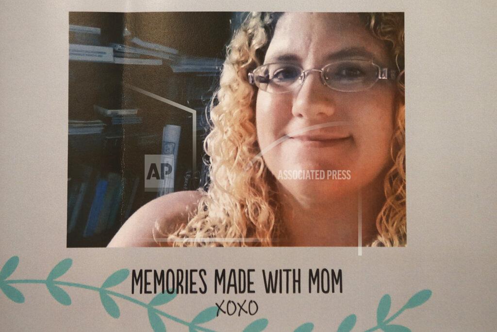 Jason Nixon This image provided by Jason Nixon, shows a photo of his wife Kate Nixon that is pasted on remembrance book from last year's shooting that took the life of Kate Nixon in Virginia Beach, Va. As the shooting's one-year anniversary approaches this weekend, some of the victim's family members say the rampage is effectively forgotten. (Jason Nixon via AP)