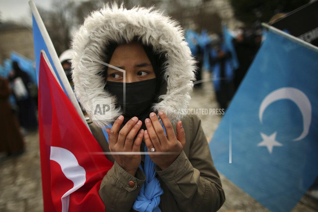Emrah Gurel A protester from the Uyghur community living in Turkey prays during a protest against the visit of China's Foreign Minister Wang Yi to Turkey, in Istanbul, Thursday, March 25, 2021. Hundreds of Uyghurs staged protests in Istanbul and the capital Ankara, denouncing Wang Yi's visit to Turkey and demanding that the Turkish government take a stronger stance against human rights abuses in China's far-western Xinjiang region. (AP Photo/Emrah Gurel)