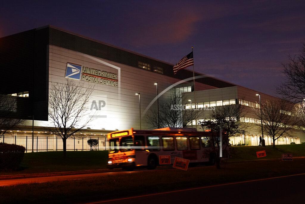 Matt Slocum A bus drives past a United States Postal Service facility, Tuesday, Nov. 3, 2020, in Philadelphia. Concerns about mail delivery delays prompted a federal judge to order postal workers in major cities to sweep processing facilities for any remaining ballots before the end of the day. (AP Photo/Matt Slocum)