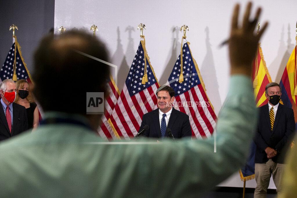 Arizona Gov. Doug Ducey listens to a question during a press conference regarding innovative COVID-19 solutions on Thursday, Sept. 24, 2020, at the Phoenix Biomedical Campus in Phoenix. (Sean Logan/The Arizona Republic via AP)