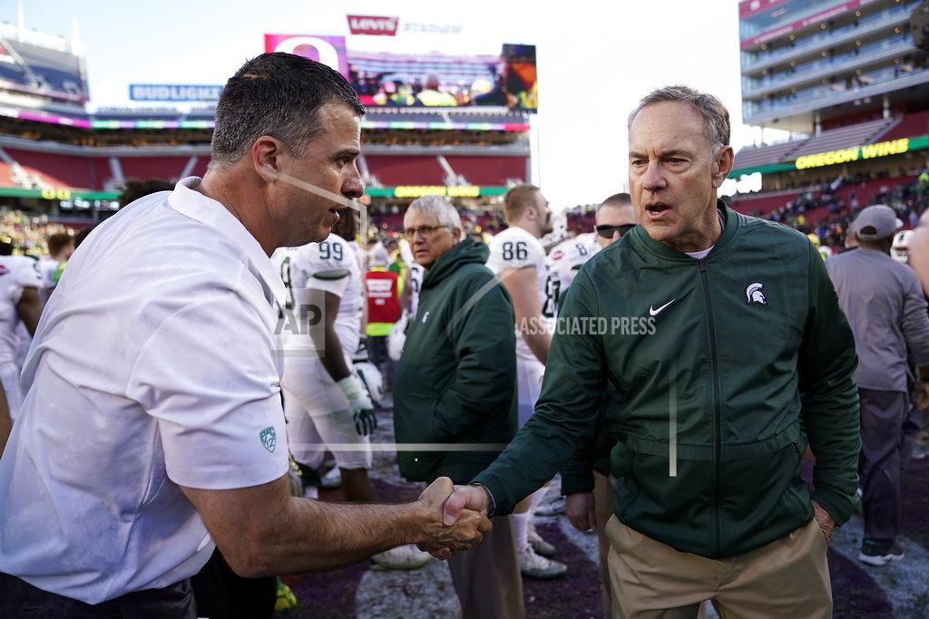 Tony Avelar Oregon head coach Mario Cristobal, left, shakes hands with Michigan State head coach Mark Dantonio at midfield after during the Redbox Bowl NCAA college football game Monday, Dec. 31, 2018, in Santa Clara, Calif. (AP Photo/Tony Avelar)