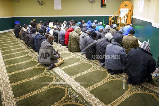 Members of the Masjid Ar Rahman pray, in the Bronx borough of New York, Wednesday, Jan. 12, 2022. The Mosque is a place of worship for some of the residents of the building which suffered the New York City's deadliest fire in three decades. (AP Photo/Mary Altaffer)