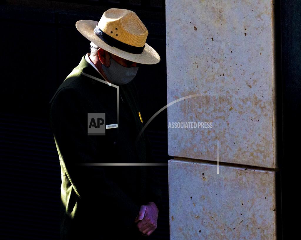 Chris Landsberger A National Park Ranger lowers his head during the 168 seconds of silence during the 26th Anniversary Remembrance Ceremony at the Oklahoma City National Memorial and Museum in Oklahoma City, Okla on Monday, April 19, 2021. (Chris Landsberger/The Oklahoman via AP)