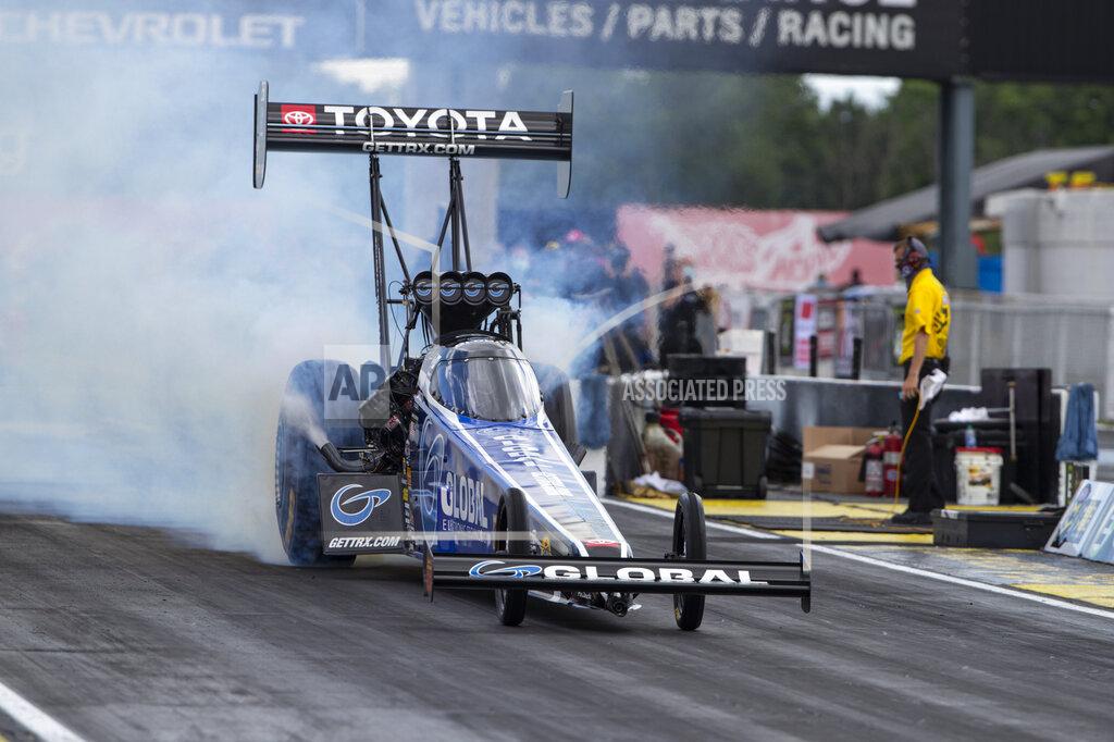 Michael Conroy Tony Schumacher does a burnout in a Top Fuel practice run for an NHRA drag racing event in Brownsburg, Ind., Friday, July 10, 2020. The NHRA returned to action last weekend near Indianapolis, in front of fans, on network television and amid hopes of a quick financial rebound following a 138-day season suspension. It was the kind of boost everybody needed. Teams and crew members are scrambling to pay the bills. Big questions remain for the world's premier drag-racing series. The pandemic is still a threat to disrupt the season or shut it down again. (AP Photo/Michael Conroy)