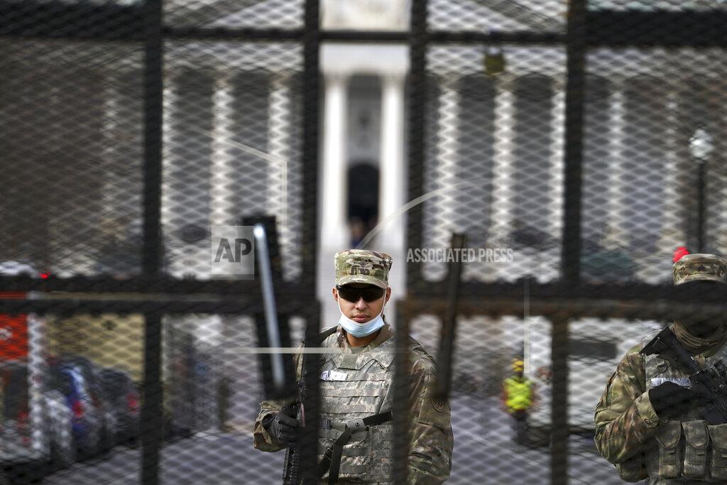 John Minchillo Members of the National Guard stand inside the security fencing at the Capitol ahead of the inauguration of President-elect Joe Biden and Vice President-elect Kamala Harris, Sunday, Jan. 17, 2021 in Washington. (AP Photo/John Minchillo)