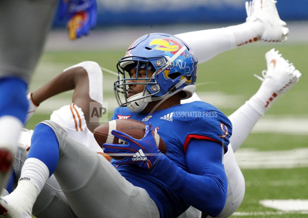 Orlin Wagner Kansas defensive end Najee Stevens-McKenzie (9) comes up with a pass interception during the first half of an NCAA college football game against Texas in Lawrence, Kan., Friday, Nov. 23, 2018. (AP Photo/Orlin Wagner)
