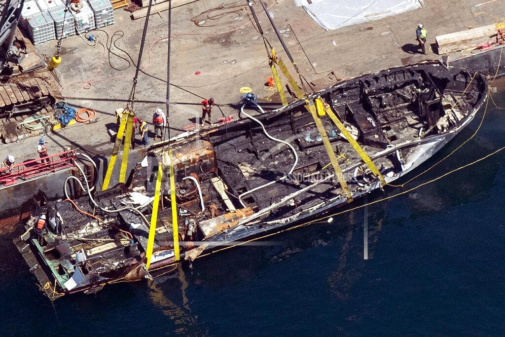 Brian Van Der Brug FILE - In this Sept. 12, 2019, file photo, the burned hull of the dive boat Conception is brought to the surface by a salvage team in the Santa Barbara Channel off Santa Cruz Island in Southern California. The families of the 34 people who perished in the boat fire on Sept. 2, 2019, have formed a group they're calling "Advocacy34" to push for strengthened boating regulations and requirements for passenger vessels, such as improved fire and safety training protocols and the installation and use of monitoring devices that would ensure there's a night watch on deck. (Brian van der Brug/Los Angeles Times via AP, File)
