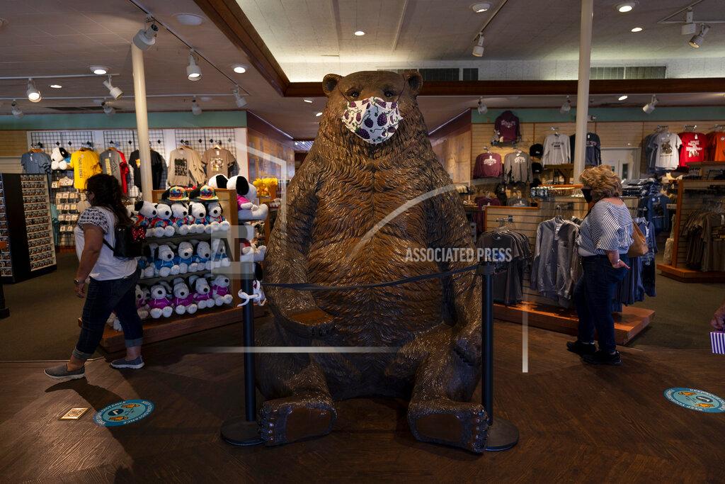 Jae C. Hong A large mask is put on a bear statue at a gift shop during the Knott's Taste of Boysenberry Festival at Knott's Berry Farm in Buena Park, Calif., Tuesday, March 30, 2021. Massive Los Angeles County can reopen even more businesses, California public health officials announced Tuesday. The county of 10 million people was one of several counties, including neighboring Orange County, that moved into the state's second-least restrictive orange tier amid low coronavirus case rates. (AP Photo/Jae C. Hong)