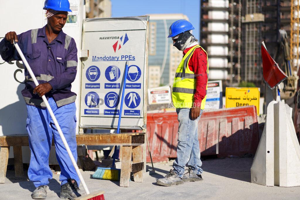Pavel Golovkin Construction cite's workers wait for trucks at a construction cite in Lusail downtown, Qatar, Thursday, Nov. 24, 2022. (AP Photo/Pavel Golovkin)