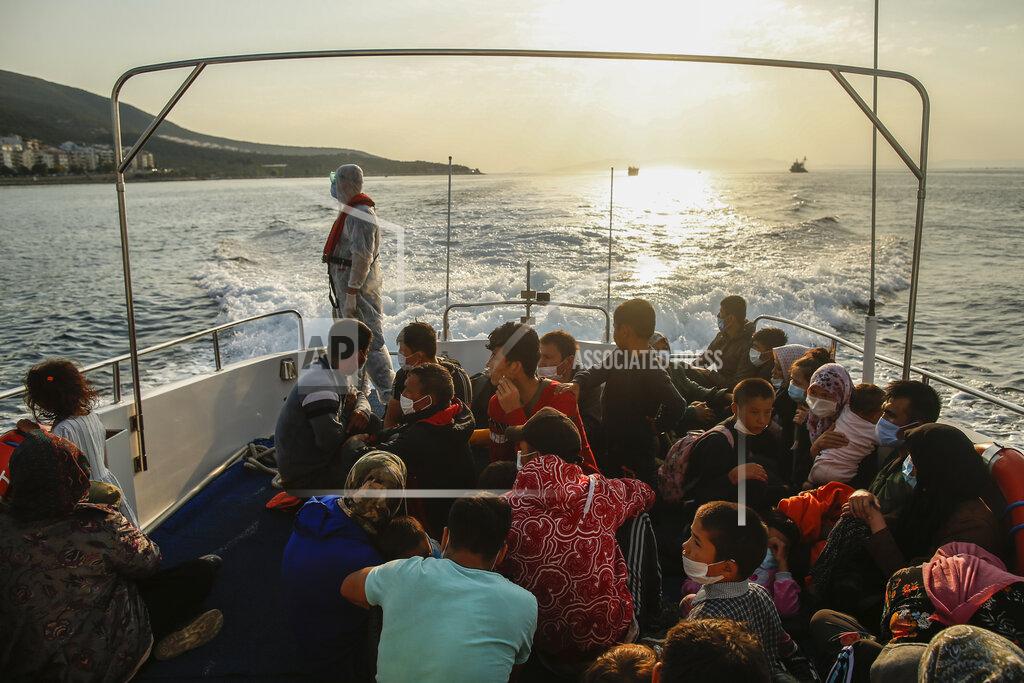 Emrah Gurel Migrants sit on a Turkish coast guard vessel after they were pulled off life rafts, during a rescue operation in the Aegean Sea, between Turkey and Greece, Saturday, Sept. 12, 2020. Turkey is accusing Greece of large-scale pushbacks at sea — summary deportations without access to asylum procedures, in violation of international law. The Turkish coast guard says it rescued over 300 migrants "pushed back by Greek elements to Turkish waters" this month alone. Greece denies the allegations and accuses Ankara of weaponizing migrants. (AP Photo/Emrah Gurel)