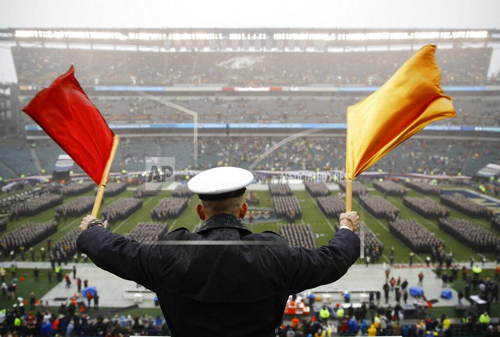 Matt Rourke FILE - A Navy Midshipman signals his classmate on the field ahead of an NCAA college football game against Army in Philadelphia, in this Saturday, Dec. 14, 2019, file photo. Bump Army-Navy or go head-to-head with NFL? That's the choice facing those in charge with expanding the College Football Playoff if they want to take the format from four to 12 teams (AP Photo/Matt Rourke, File)