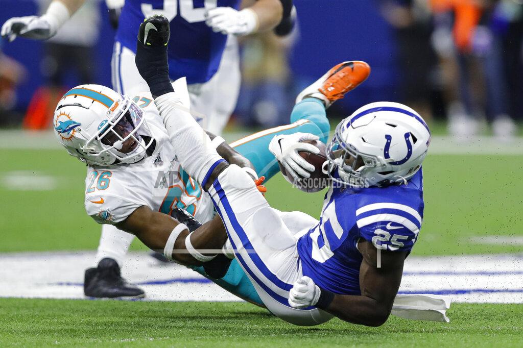 Darron Cummings Indianapolis Colts running back Marlon Mack (25) is tackled by Miami Dolphins defensive back Steven Parker (26) during the first half of an NFL football game in Indianapolis, Sunday, Nov. 10, 2019. (AP Photo/Darron Cummings)