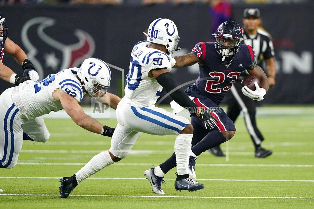 David J. Phillip Houston Texans running back Carlos Hyde (23) runs past Indianapolis Colts middle linebacker Anthony Walker (50) during the first half of an NFL football game Thursday, Nov. 21, 2019, in Houston. (AP Photo/David J. Phillip)