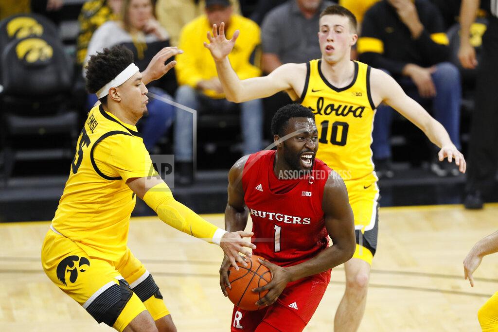 Charlie Neibergall Rutgers forward Akwasi Yeboah (1) drives between Iowa's Cordell Pemsl, left, and Joe Wieskamp, right, during the first half of an NCAA college basketball game, Wednesday, Jan. 22, 2020, in Iowa City, Iowa. (AP Photo/Charlie Neibergall)