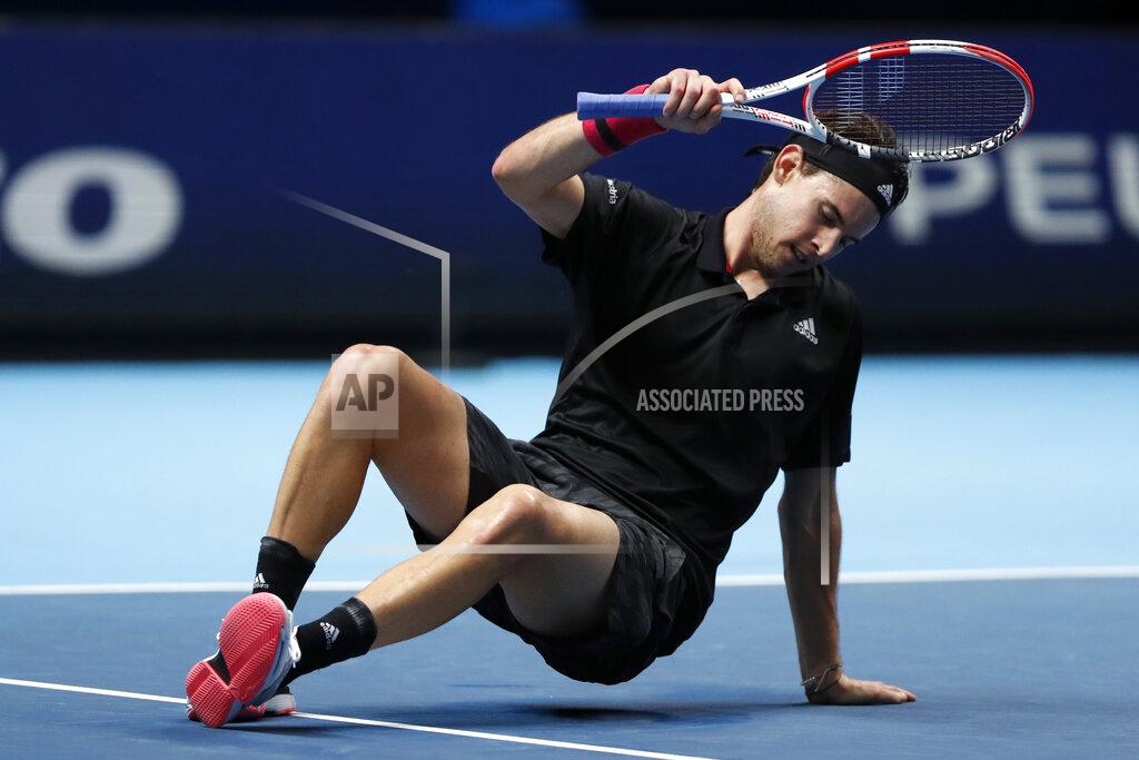 Frank Augstein Dominic Thiem of Austria slips over as he plays against Daniil Medvedev of Russia during their singles final tennis match at the ATP World Finals tennis tournament at the O2 arena in London, Sunday, Nov. 22, 2020. (AP Photo/Frank Augstein)