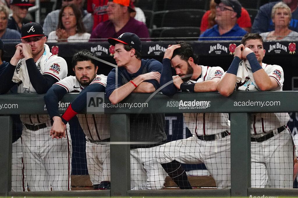 John Bazemore The Atlanta Braves watch from the dugout in the ninth inning of their 5-4 loss to Colorado Rockies in a baseball game Tuesday, Sept. 14, 2021, in Atlanta. (AP Photo/John Bazemore)
