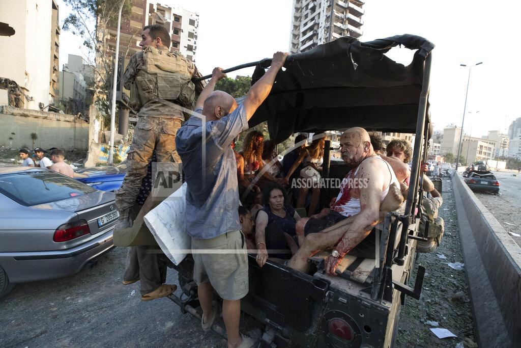 Hassan Ammar Army soldiers evacuate injured people after a massive explosion in Beirut, Lebanon, Tuesday, Aug. 4, 2020. Massive explosions rocked downtown Beirut on Tuesday, flattening much of the port, damaging buildings and blowing out windows and doors as a giant mushroom cloud rose above the capital. Witnesses saw many people injured by flying glass and debris. (AP Photo/Hassan Ammar)