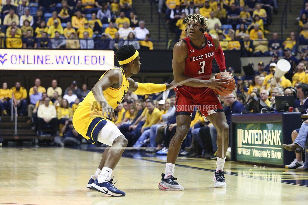 Kathleen Batten Texas Tech guard Jahmi'us Ramsey (3) drives upcourt as he is defended by West Virginia guard Brandon Knapper, left, during the first half of an NCAA college basketball game Saturday, Jan. 11, 2020, in Morgantown, W.Va. (AP Photo/Kathleen Batten)