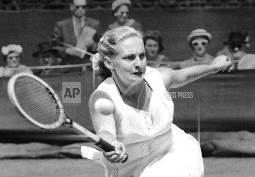 FILE - Darlene Hard hits a forehand to Zsuzsa Kormoczy during a quarterfinal on June 28, 1955 at Wimbledon tennis championships in London. Hard, an aggressive serve-and-volley player who won three major singles titles as well as 18 major doubles titles in a Hall of Fame tennis career, died Thursday, Dec. 2, 2021, after a brief illness. She was 85. (AP Photo, File)
