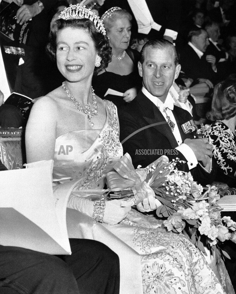 Uncredited FILE - Queen Elizabeth II appears with her husband, Prince Philip, Duke of Edinburgh, at the Empire Theatre in London for the world premiere of the film "Dunkirk," on March 20, 1958. (AP Photo, File)