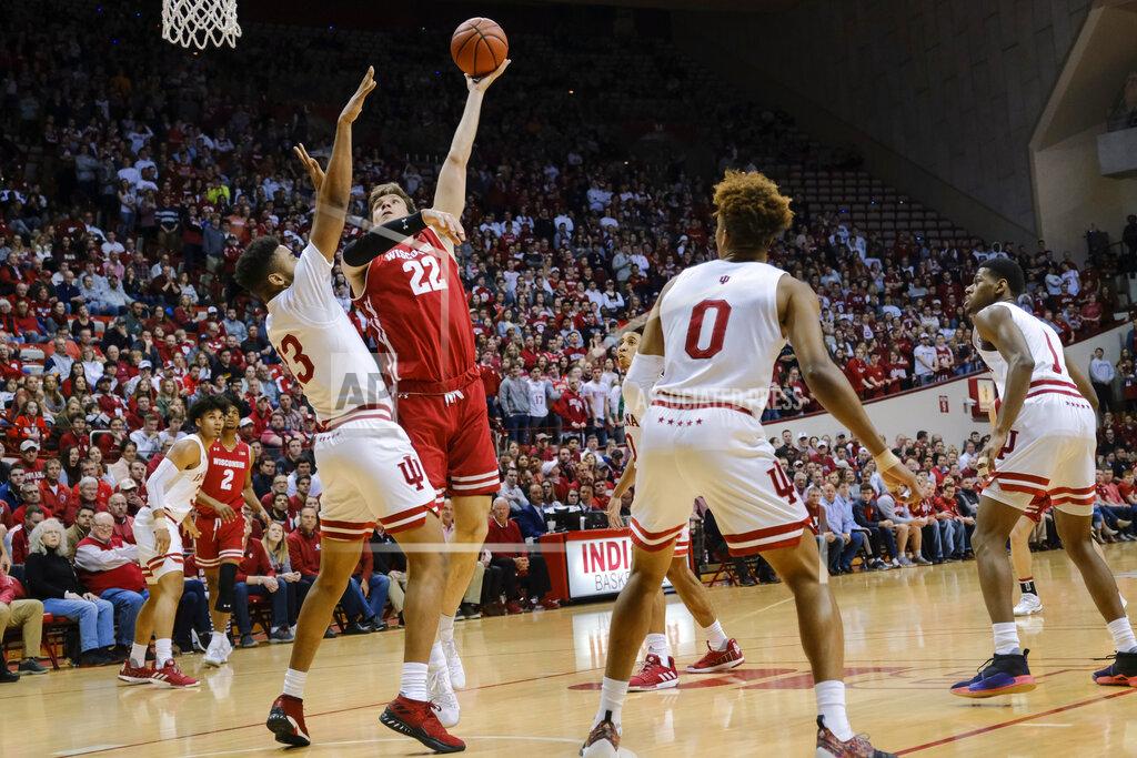 Aj Mast Wisconsin forward Ethan Happ (22) shoots over Indiana forward Juwan Morgan (13) during the first half of an NCAA college basketball game in Bloomington, Ind., Tuesday, Feb. 26, 2019. (AP Photo/AJ Mast)