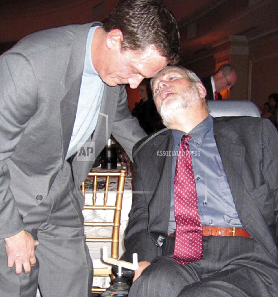 Michael Sisak In this 2005 photo, Christopher Pendergast meets with former Mets and Yankees pitcher David Cone at a fundraising gala organized students in the school district where he taught. Pendergast, a suburban New York teacher who turned a dreaded Lou Gehrig’s Disease diagnosis into a decades-long campaign to raise awareness and fund research, died from the illness on Wednesday, OCt. 14, 2020. He was 71. (AP Photo/Michael Sisak). (AP Photo/Michael Sisak)