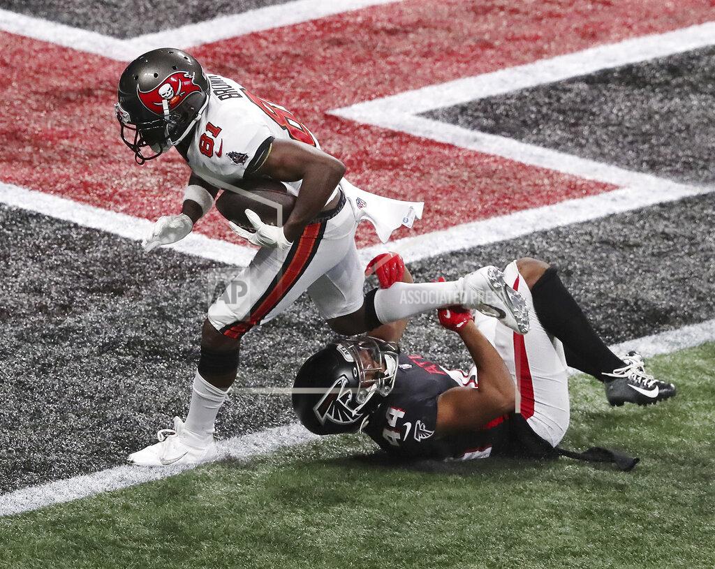 Curtis Compton Tampa Bay Buccaneers wide receiver Antonio Brown, top, gets past Atlanta Falcons cornerback Tyler Hall for what proved to be the winning touchdown in the final minutes of an NFL football game Sunday, Dec. 20, 2020, in Atlanta. (Curtis Compton/Atlanta Journal-Constitution via AP)