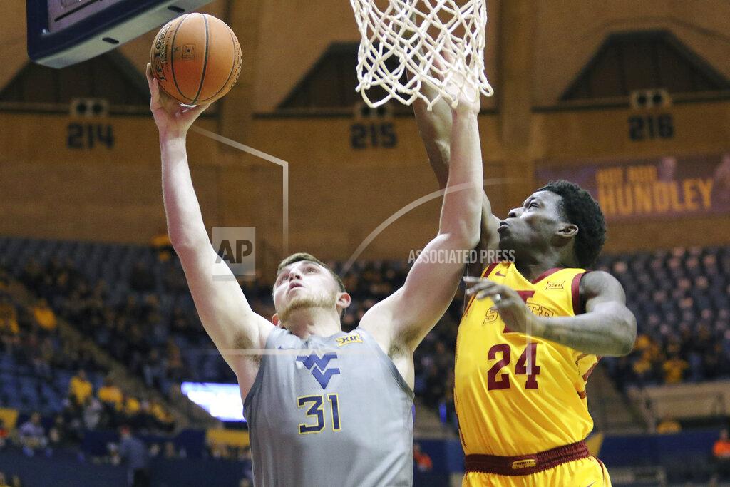 Kathleen Batten West Virginia forward Logan Routt (31) goes up for a shot as he is defended by Iowa State guard Terrence Lewis (24) during the second half of an NCAA college basketball game Wednesday, Feb. 5, 2020, in Morgantown, W.Va. (AP Photo/Kathleen Batten)