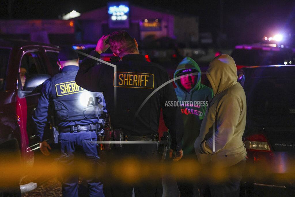 Gabrielle Lurie Sheriff's deputies talk with people at the scene of a deadly shooting where several fatalities occurred off state Highway 92 in Half Moon Bay, Calif., on Monday, Jan. 23, 2023. (Gabrielle Lurie/San Francisco Chronicle via AP)